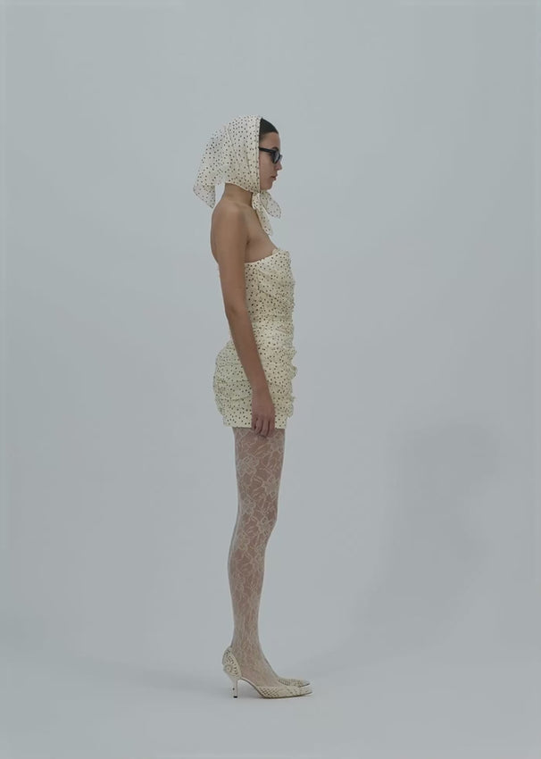 Crafted from luxurious ruched silk, this strapless mini dress features elegant all-over draping that creates a refined silhouette. The understated design delivers effortless sophistication, while the fluid fabric movement adds dimension and grace. Perfect for evening occasions or upscale casual moments, this piece balances minimalist aesthetics with timeless allure.