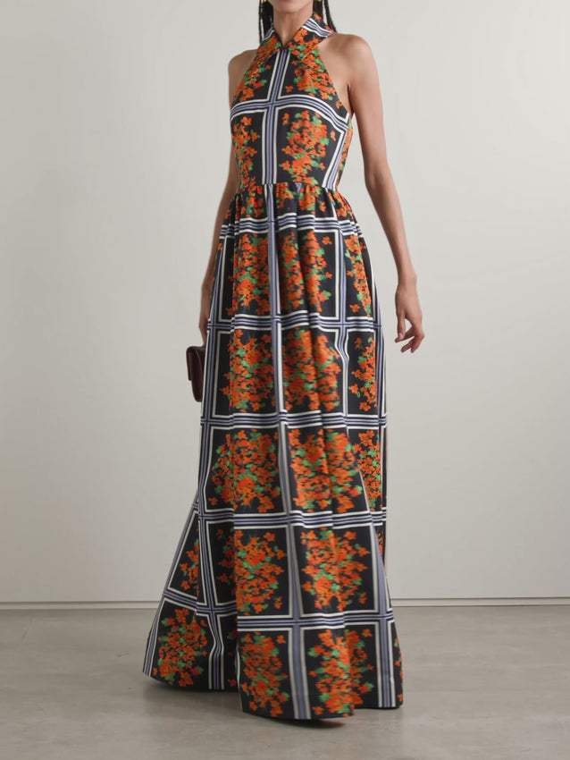 Embrace timeless elegance with this printed faille halterneck gown, featuring a charming windowpane floral pattern inspired by vintage '50s design. The structured bodice hugs your silhouette beautifully before transitioning into a gracefully voluminous skirt. Practical side pockets add modern convenience to this sophisticated piece, making it perfect for special occasions where style meets comfort.
