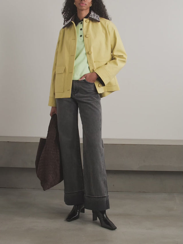 Upgrade your outerwear game with the Arlen Dickey coat from Veronica Beard. This luxury piece features a detachable canvas collar adorned with dazzling crystals, adding a touch of glamour to classic workwear. Crafted from structured coated-cotton, its relaxed fit provides comfortable layering over sweaters. Elevate your style with this sophisticated and exclusive coat.