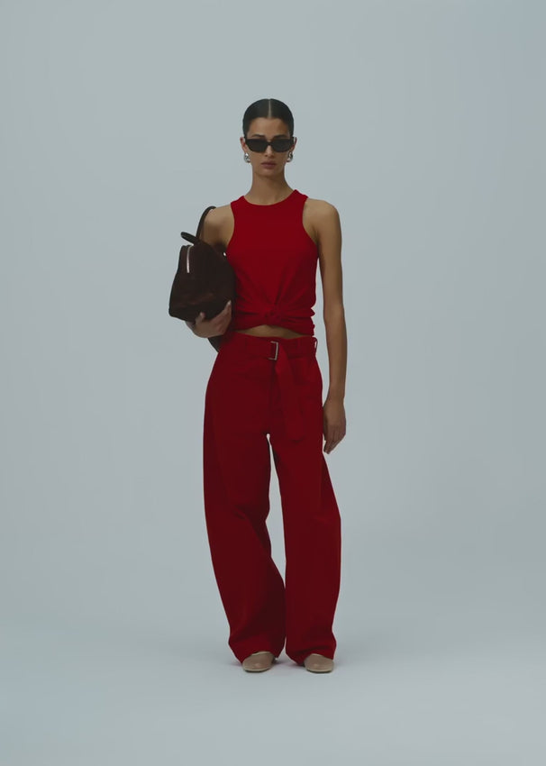 Magda Butrym's iconic ribbed silhouette reimagined as a sleek tank top. A signature knotted detail at the front adds dimension and visual interest to this wardrobe essential. Crafted from a soft cotton-elastane blend for comfort and subtle stretch, this piece transitions effortlessly from day to evening wear.