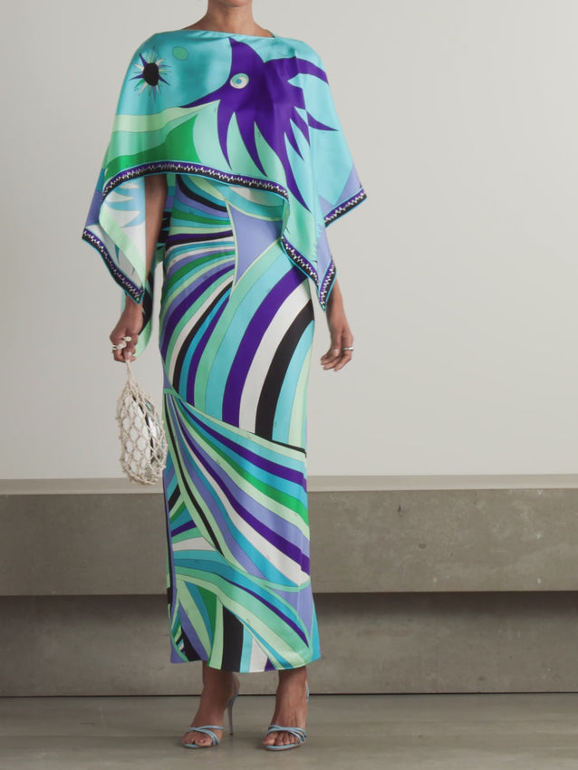 The signature swirling print of PUCCI defines this luxurious maxi dress, tailored from sumptuous silk-twill that drapes with fluid grace. A layered overlay fashions an elegant cape silhouette, complemented by relaxed kimono sleeves for understated sophistication. Style with bold statement earrings and sleek mules to complete the refined ensemble.