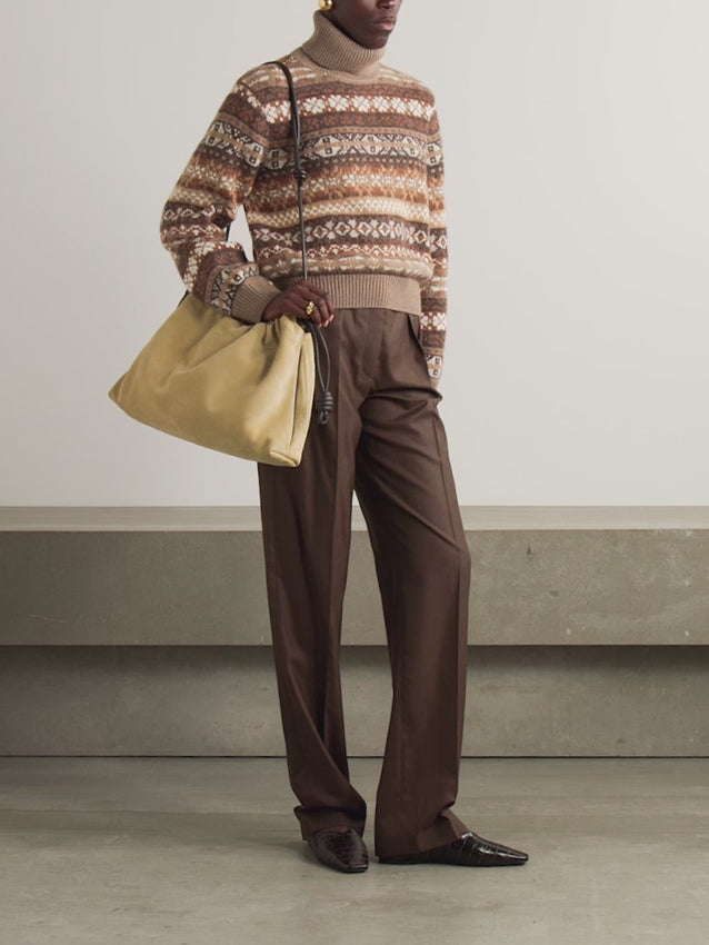 Embrace winter elegance with the Scopello turtleneck by Loro Piana, a masterpiece of Italian craftsmanship. This luxurious jacquard-knit sweater blends soft cashmere, alpaca, and wool in a timeless Fair Isle pattern, delivering both warmth and refined style. The classic turtleneck design offers versatile sophistication—perfect for layering or wearing solo. Whether tucked or loose, this investment piece transitions seamlessly from casual weekends to polished occasions.