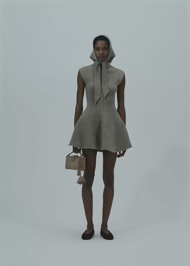 This marled knit skater dress features a flattering flared skirt and a sleeveless design that enhances a feminine silhouette. Its soft knit fabric provides comfortable wear, making it an effortless choice for both casual and dressier occasions. Ideal for those seeking style without sacrificing comfort.