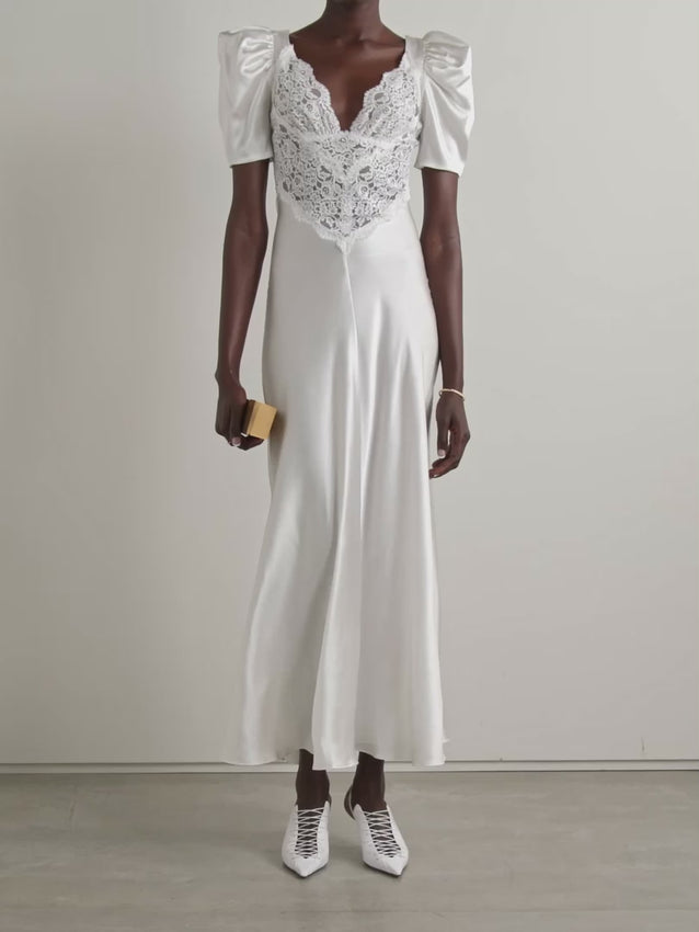 Rodarte crafts the perfect bridal moment with this exquisite gown. Cut on the bias from luxurious silk-satin, it drapes gracefully against your silhouette while a delicate lace-paneled bodice adds romantic detail. Vintage-inspired puffed sleeves complete this timeless design for your special day.