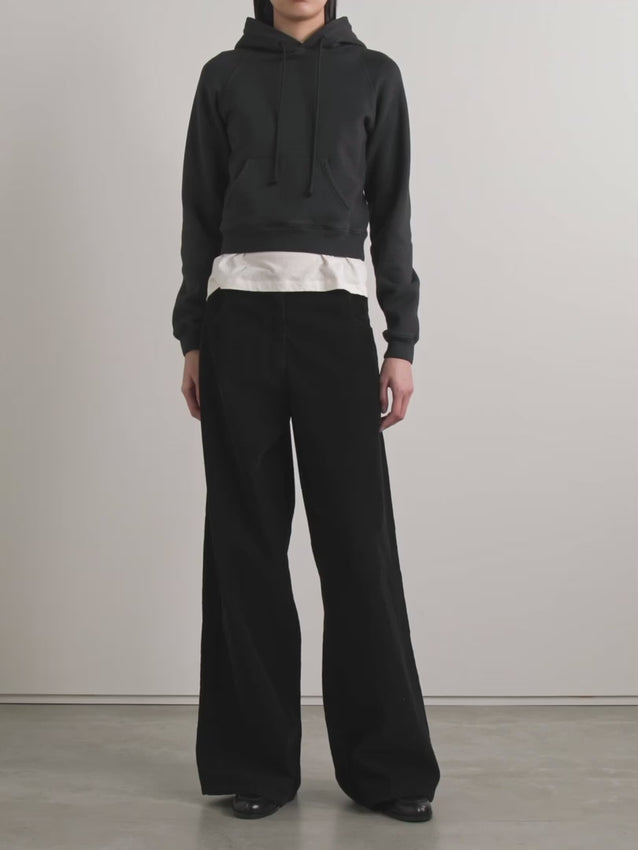 The Timmi cotton-blend jersey hoodie by The Row redefines casual elegance. Crafted from soft fleece-backed cotton blend, it offers exceptional comfort with refined texture. Its cropped silhouette pairs impeccably with high-rise jeans or trousers, while the practical kangaroo pocket adds subtle functionality. Perfect for those seeking understated sophistication in everyday wear.