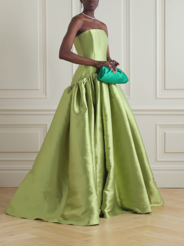 Introducing the Cassia strapless pleated satin-twill gown by Solace London. This sophisticated evening piece features a strapless silhouette with elegant pleated detailing across the bodice, crafted from luxurious satin-twill fabric that drapes beautifully. The refined construction and timeless design make it an ideal choice for formal occasions, galas, and special events. The structured pleats add dimension and movement, while the smooth satin-twill finish delivers a polished, high-end aesthetic. 