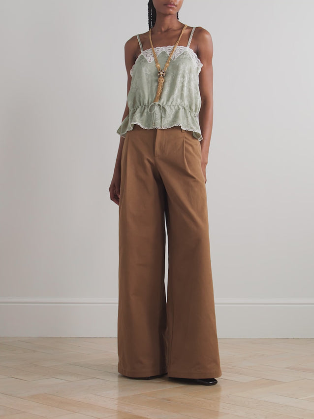 Reimagine Y2K elegance with this Chloé camisole, where nostalgic charm meets contemporary sophistication. Crafted from luxurious silk-jacquard adorned with delicate floral motifs, it features refined lace trim and adjustable waist ties that sculpt a flattering peplum silhouette, finished with a delicate picot hem.