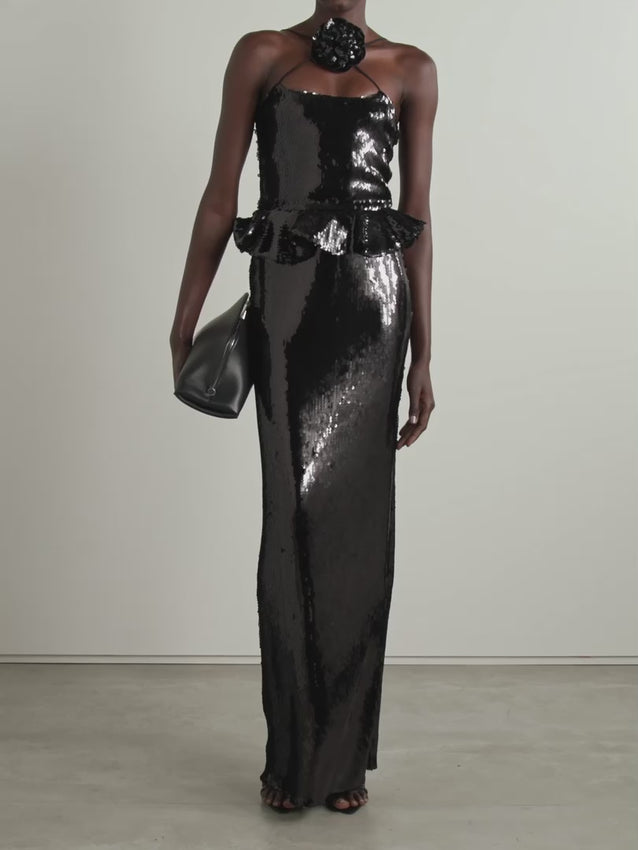 This Sequined Tulle Peplum Gown from Rodarte captures a unique romantic elegance. Crafted from delicate tulle and adorned with shimmering sequins, it glows beautifully from every angle. The detachable flower brooch at the neck adds a charming touch, while the full lining ensures comfort and the back vent allows ease of movement. It’s a stunning choice for making a memorable entrance with grace and style.